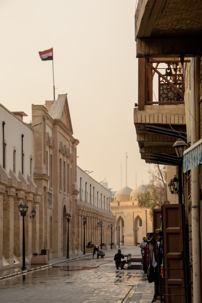 A city street with a few people walking on it