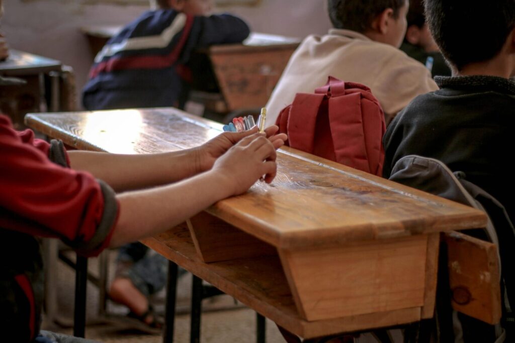 A focused view of students studying in a classroom in Idlib, Syria.