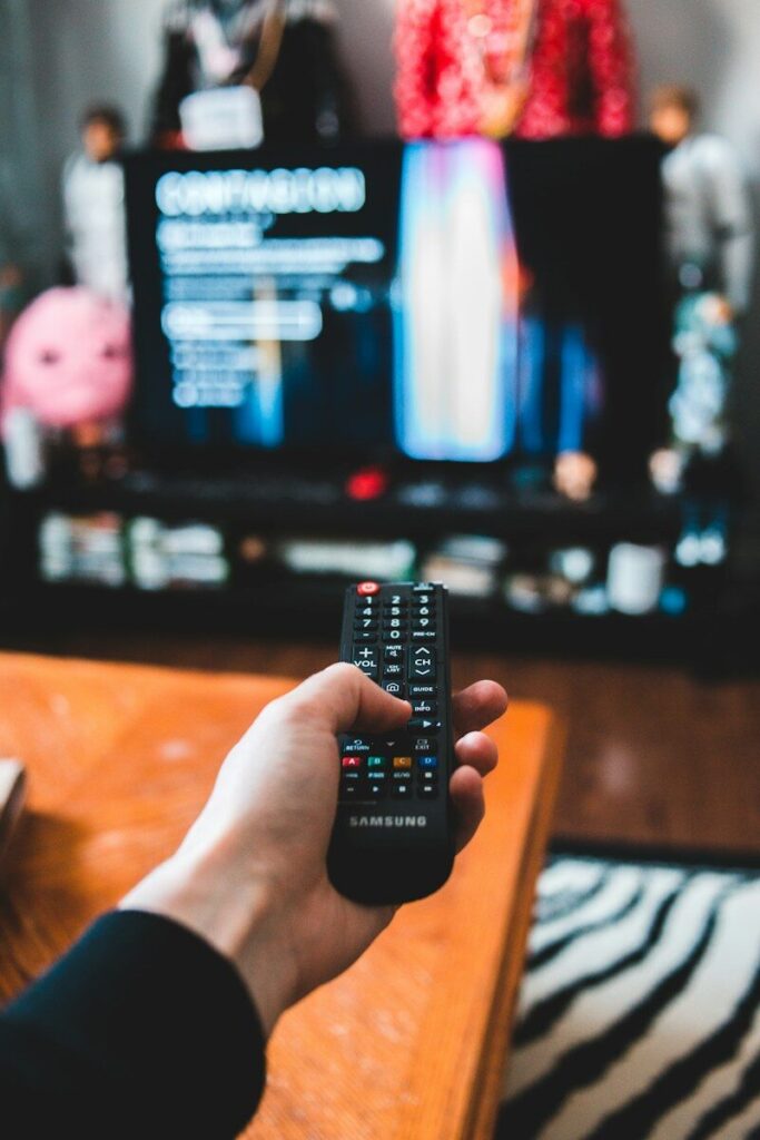 صورة لشخص يتفحص إعدادات التلفيزيون/المصدر/Pexels